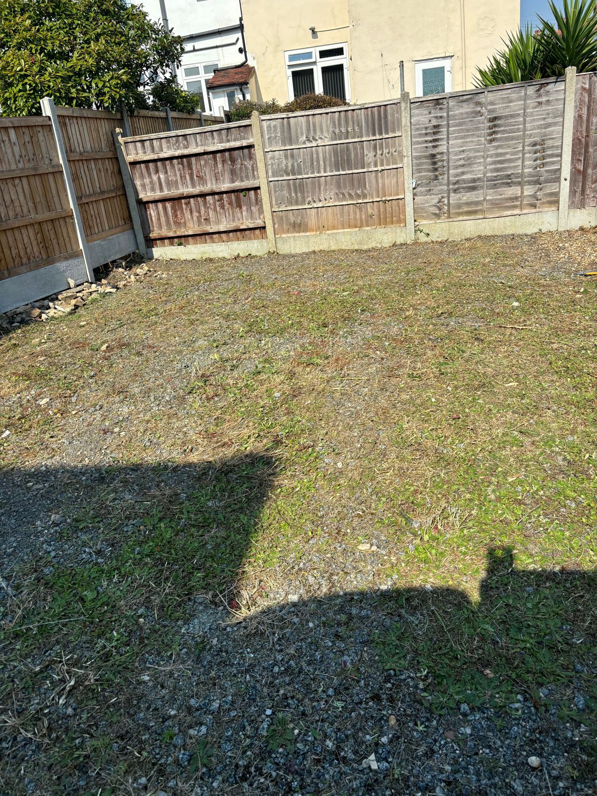 The same rear garden after the growth was cleared.